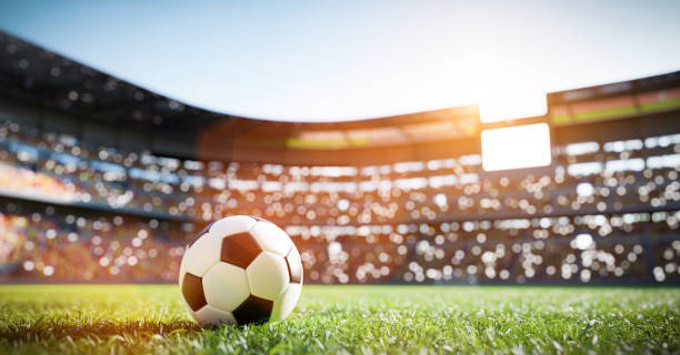 Football soccer ball on grass field on stadium. Sport